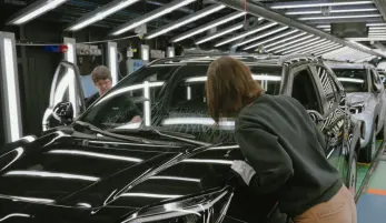 ligne d'assemblage usine Toyota avec ouvriers, ouvrières, et les voitures en cours d'assemblage